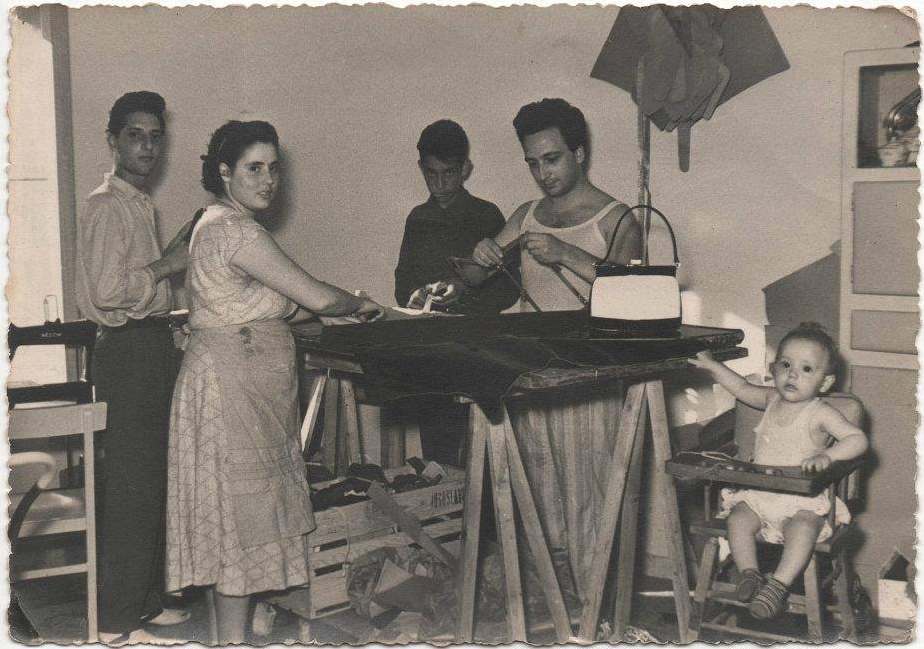 Historical photo (1959): The Del Giudice family creating handcrafted Italian leather bags in their kitchen-workshop in Rome