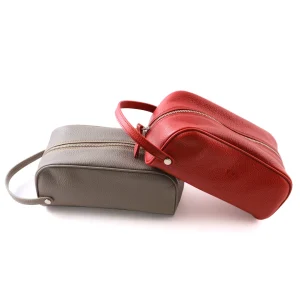 Men's leather dopp bag in taupe and leather toiletry bag for women in red