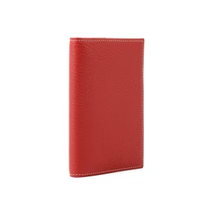 Side view of cherry red leather passport holder, showcasing compact and sleek design